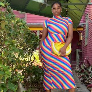Woman in a rainbow striped maxi dress