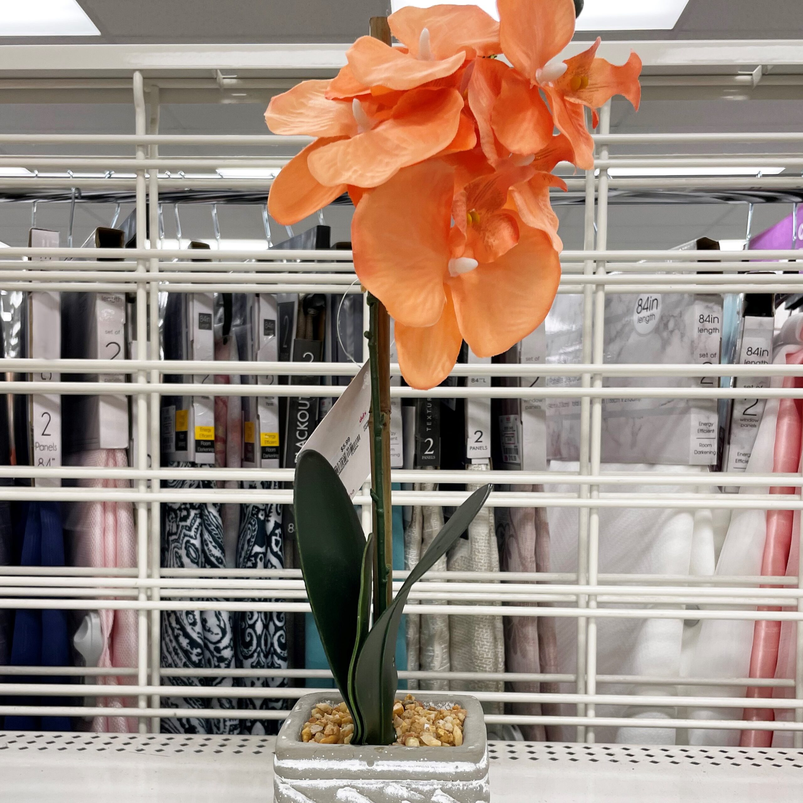 Orange faux flower with decorative pot from dd's discounts.